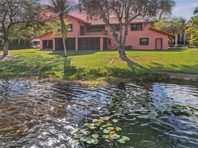 221 NW 201st Ave, Pembroke Pines, FL 33029 - back of property featuring stucco siding, a lawn, a balcony, and a tile roof