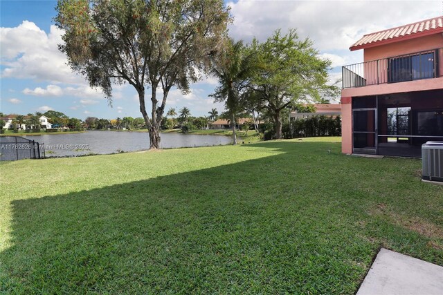 221 NW 201st Ave, Pembroke Pines, FL 33029 - view of green lawn with a water view, a sunroom, central AC unit, and a balcony
