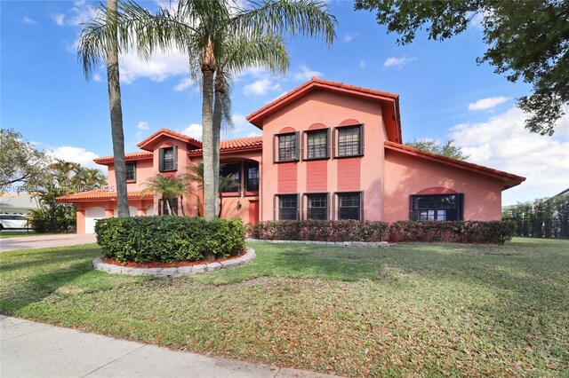 221 NW 201st Ave, Pembroke Pines, FL 33029 - mediterranean / spanish house featuring stucco siding, a tile roof, a front lawn, and a garage