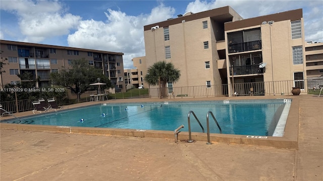 view of pool featuring fence