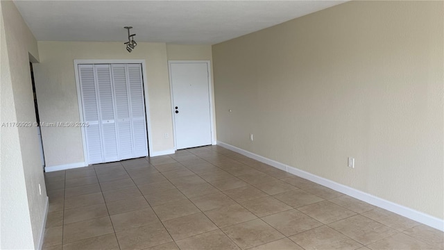 spare room with baseboards