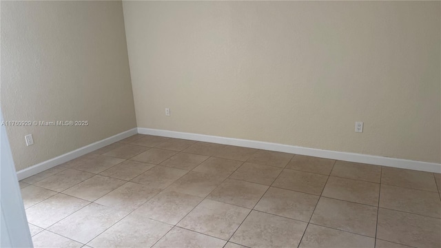 empty room featuring baseboards