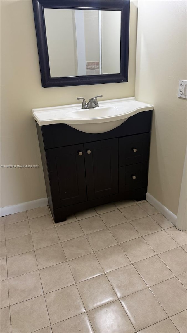 bathroom featuring baseboards, vanity, and tile patterned flooring