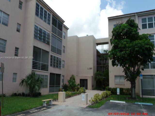 view of building exterior with uncovered parking