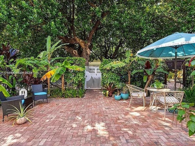 view of patio / terrace featuring fence and a gate