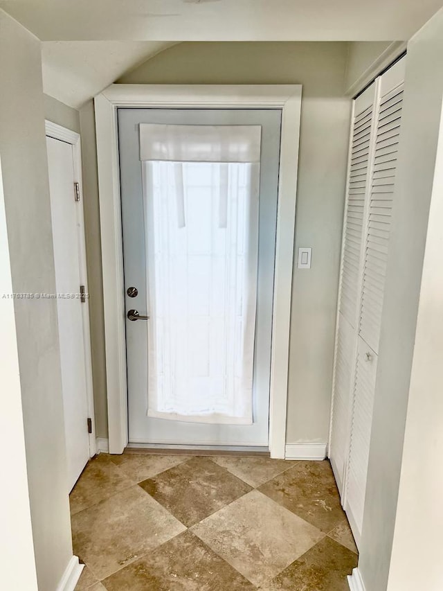 doorway to outside featuring baseboards