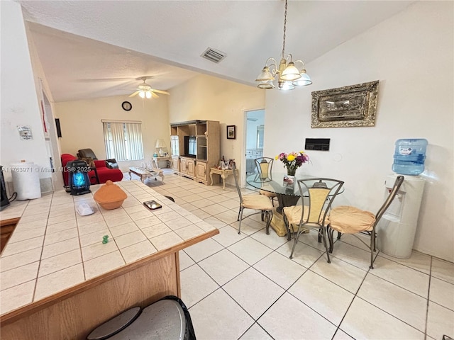 dining area with light tile patterned floors, visible vents, lofted ceiling, and ceiling fan with notable chandelier