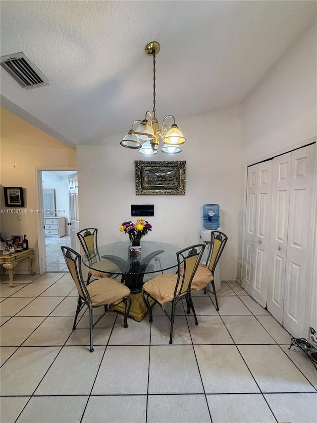 dining space featuring vaulted ceiling, a notable chandelier, light tile patterned floors, and visible vents