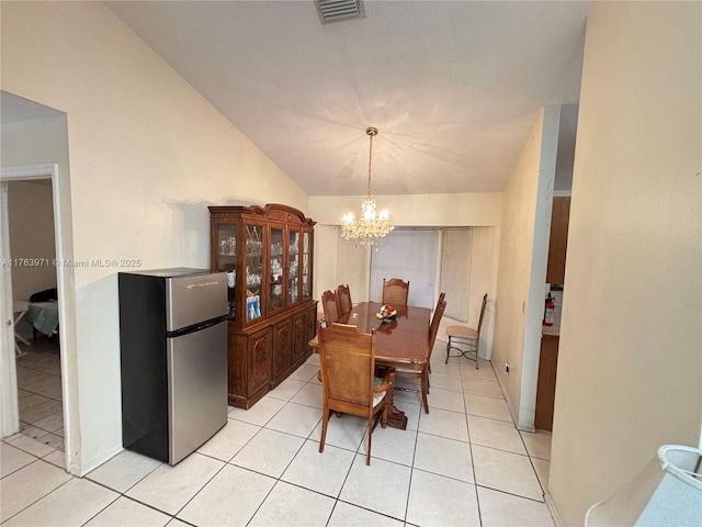 dining space with an inviting chandelier, lofted ceiling, light tile patterned floors, and visible vents