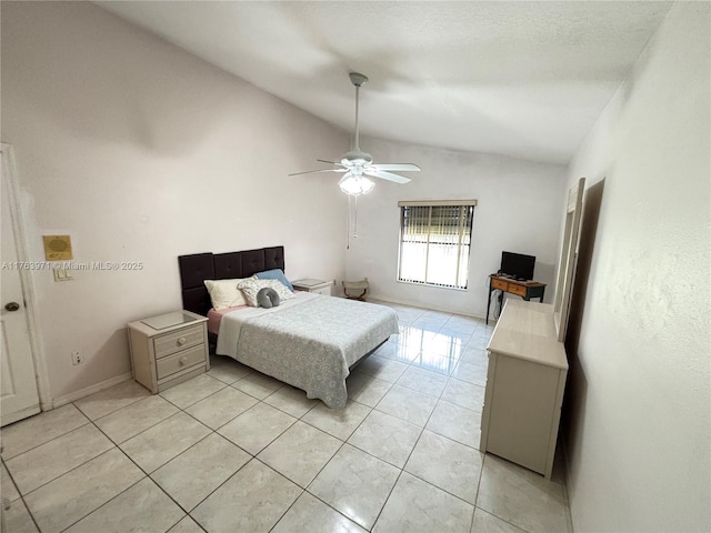 bedroom with light tile patterned floors, ceiling fan, baseboards, and vaulted ceiling