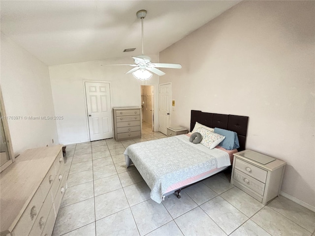 bedroom with vaulted ceiling, light tile patterned flooring, a ceiling fan, and visible vents