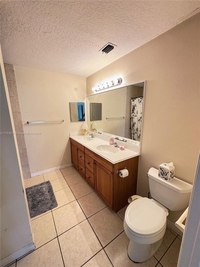 bathroom with tile patterned floors, toilet, visible vents, and a sink