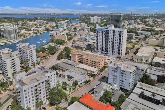 birds eye view of property featuring a water view and a city view