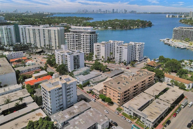 birds eye view of property with a city view and a water view