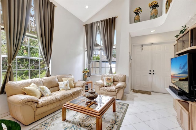 living room with light tile patterned floors, recessed lighting, a wealth of natural light, and high vaulted ceiling