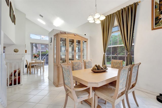 dining room with light tile patterned floors, a notable chandelier, high vaulted ceiling, and visible vents