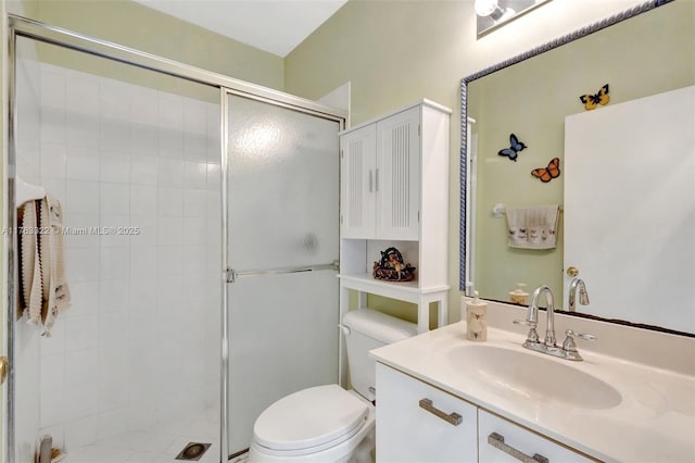 bathroom with vanity, toilet, and a stall shower