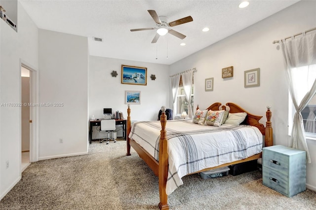 carpeted bedroom with a ceiling fan, visible vents, baseboards, recessed lighting, and a textured ceiling