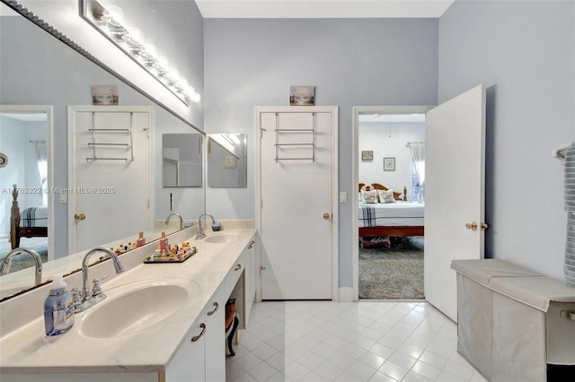 full bath with a sink, ensuite bath, and double vanity