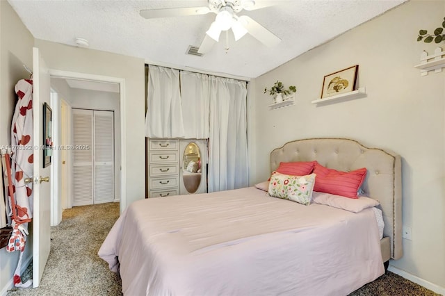 bedroom with ceiling fan, visible vents, carpet floors, and a textured ceiling