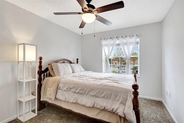 carpeted bedroom with ceiling fan, baseboards, and a textured ceiling