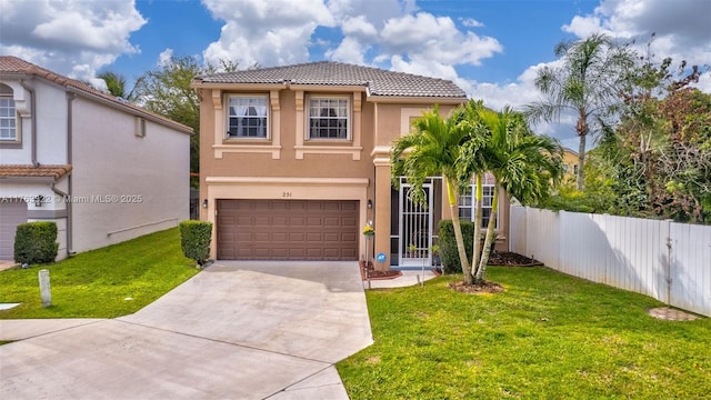 mediterranean / spanish-style home featuring stucco siding, a front lawn, driveway, and fence