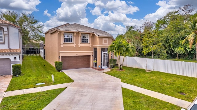 mediterranean / spanish house featuring a front yard, fence, driveway, stucco siding, and a garage