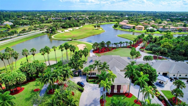 aerial view featuring a residential view, golf course view, and a water view