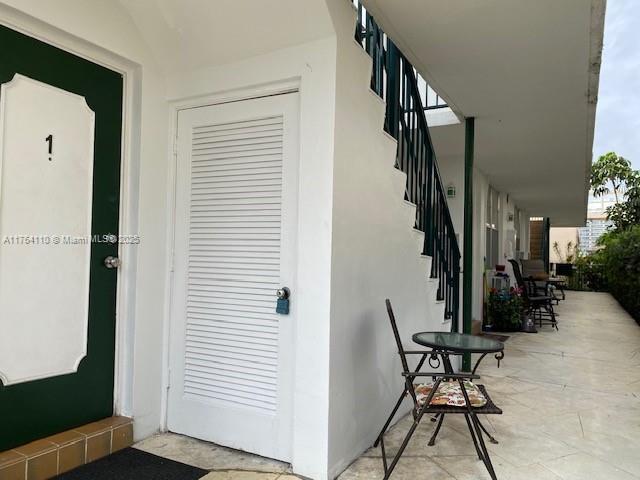 doorway to property featuring stucco siding