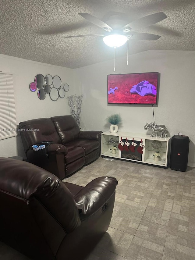 living room with tile patterned floors, a textured ceiling, and ceiling fan