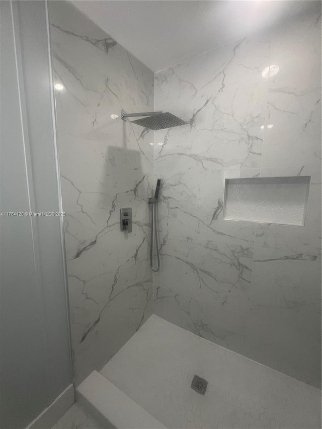 full bath featuring a marble finish shower