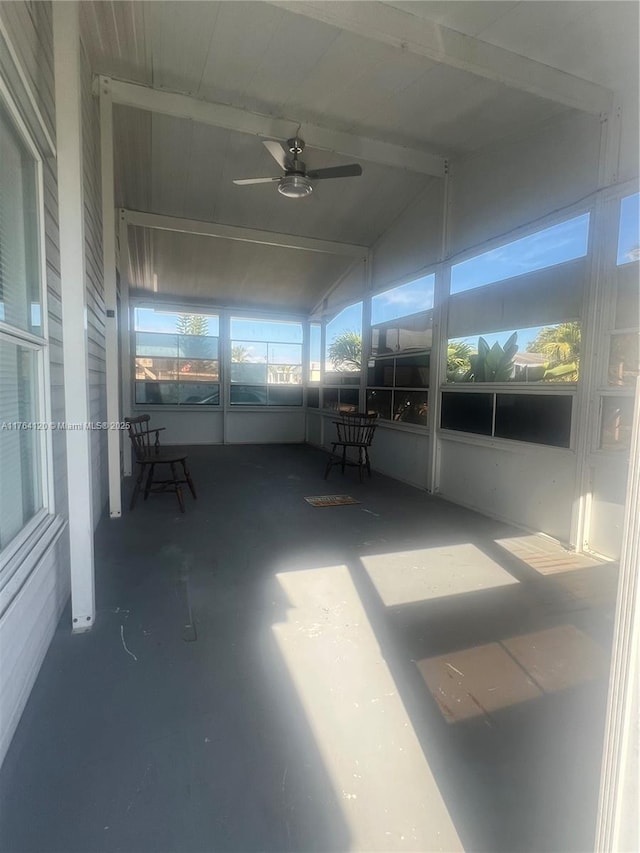 unfurnished sunroom featuring lofted ceiling and ceiling fan