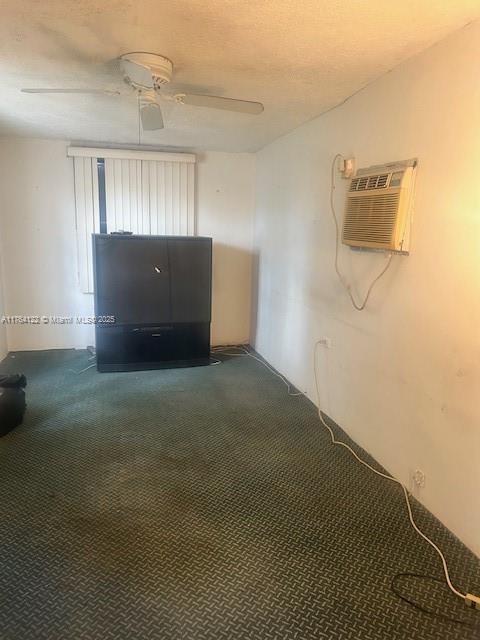 unfurnished room featuring carpet flooring, an AC wall unit, and a ceiling fan