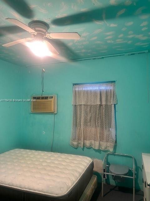 bedroom featuring a wall mounted air conditioner and ceiling fan