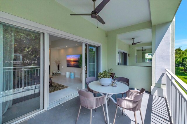 balcony with outdoor dining area and a ceiling fan