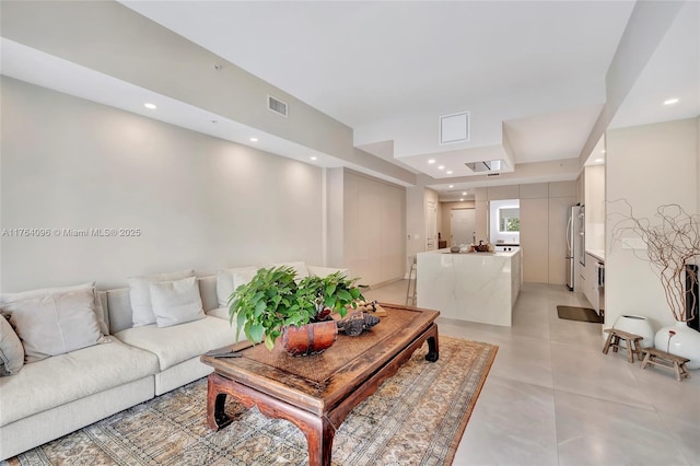 living area featuring light tile patterned floors, visible vents, and recessed lighting