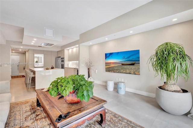 living area with recessed lighting and baseboards