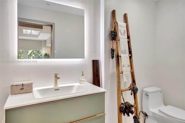 bathroom with toilet and vanity