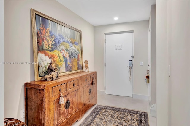 foyer entrance featuring recessed lighting and baseboards