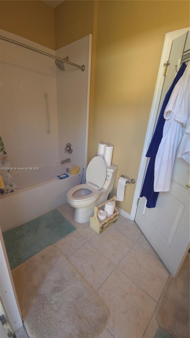 bathroom with shower / tub combination, toilet, and baseboards