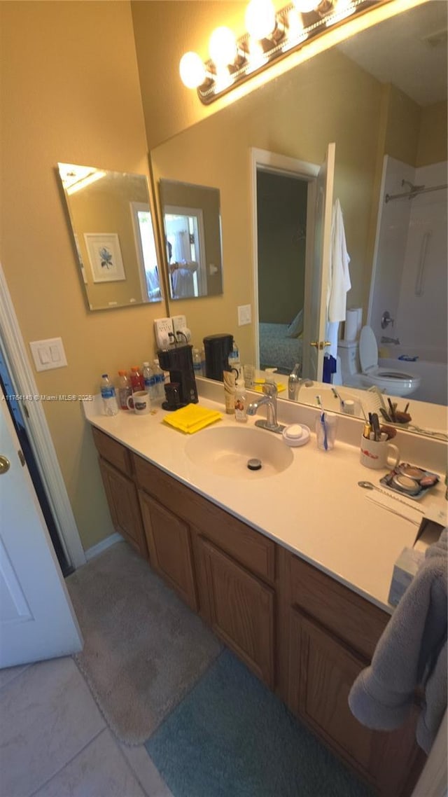 bathroom featuring vanity, tile patterned flooring, shower / bath combination, toilet, and connected bathroom