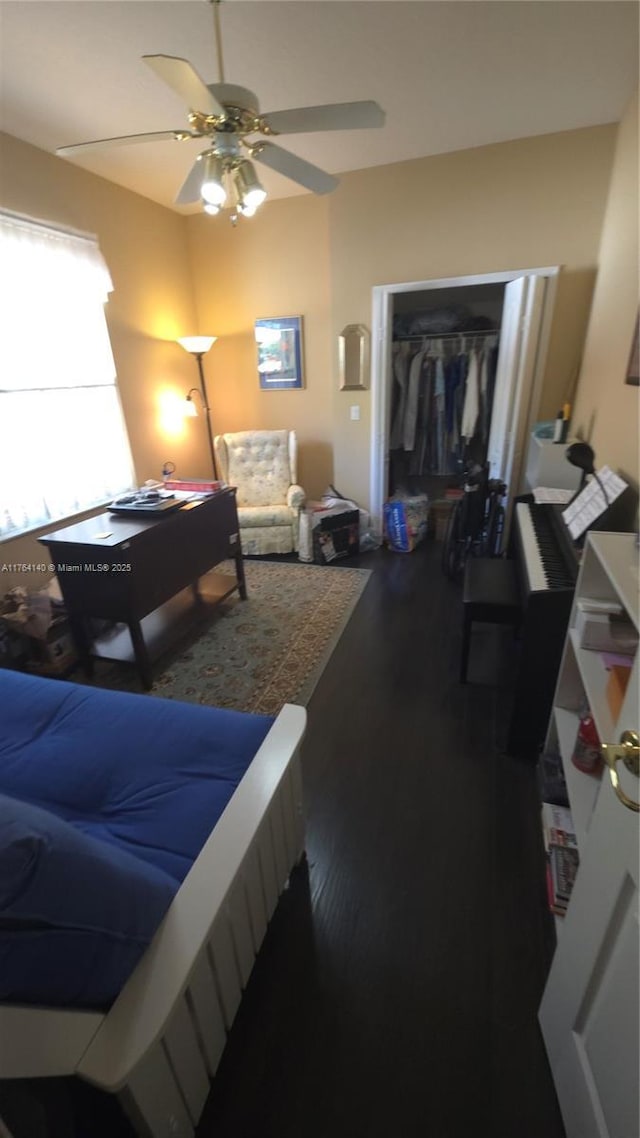 bedroom with a closet, a ceiling fan, and wood finished floors