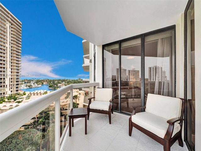 balcony with a water view and a city view