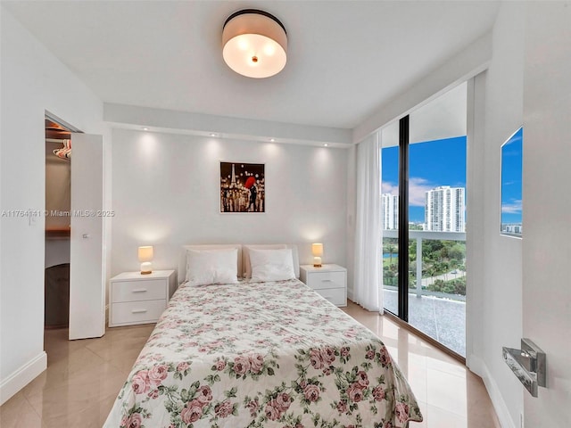 bedroom featuring access to exterior, a city view, baseboards, and light tile patterned floors