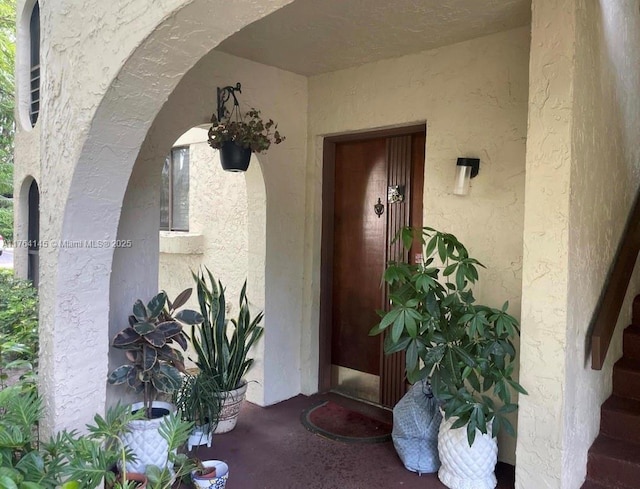 doorway to property with stucco siding