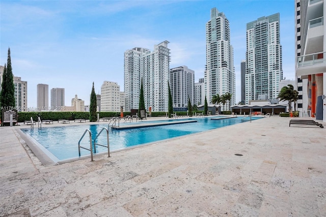 community pool featuring a patio area and a city view