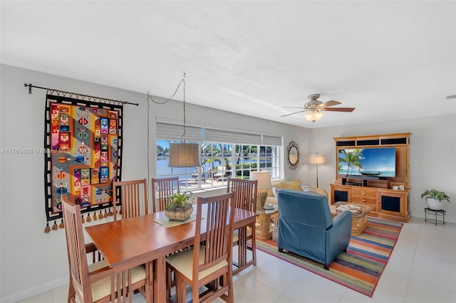 dining space with light tile patterned floors and a ceiling fan