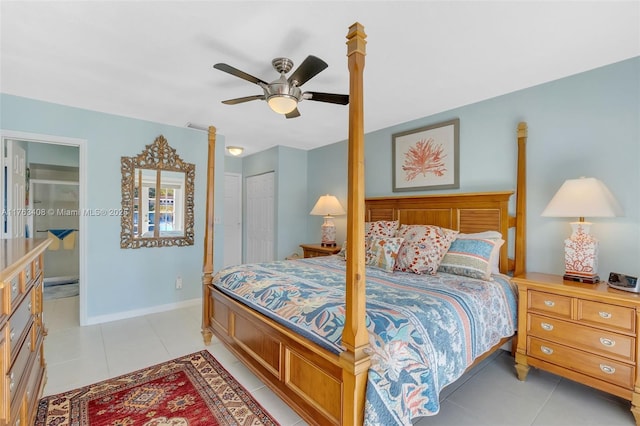 bedroom with light tile patterned floors, ceiling fan, baseboards, and a closet