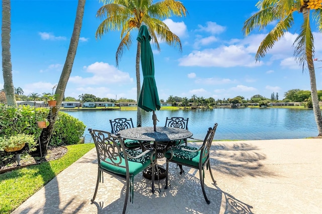 view of patio / terrace featuring outdoor dining space and a water view