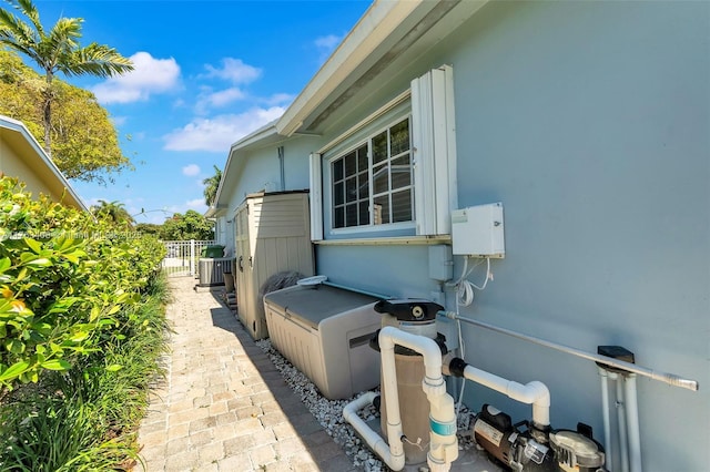 view of home's exterior with fence and stucco siding